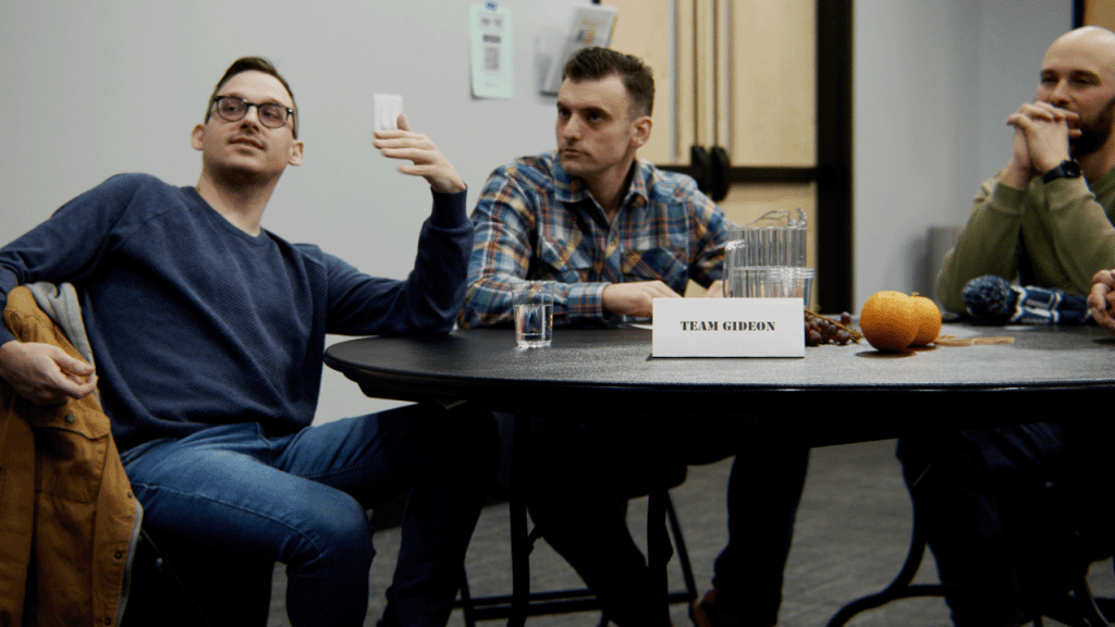 Men around a ManTime table.